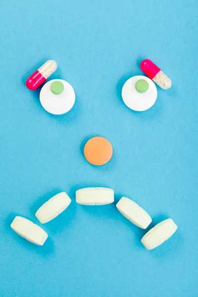 Sad smileyface made of pills