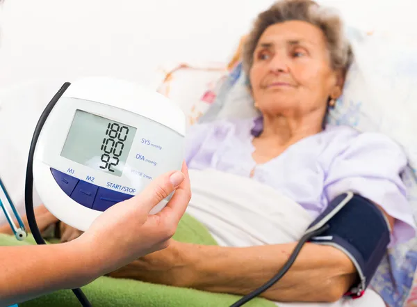 Nurse using digital blood pressure measure