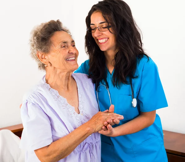 Nurses caring about elderly patient