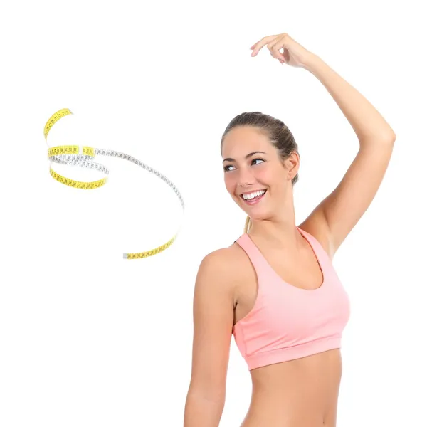 Beautiful fitness woman throwing a tape measure
