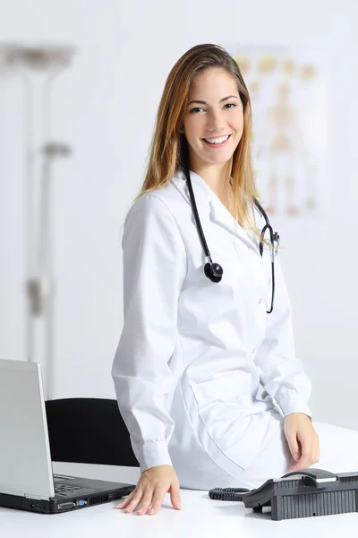 Beautiful female doctor in her consultation