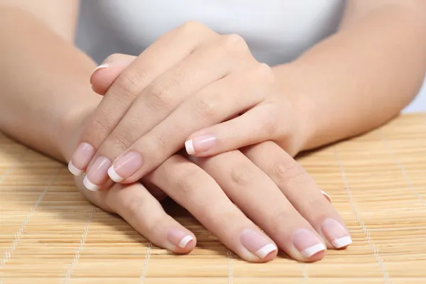 Beautiful woman hands and nails with perfect french manicure