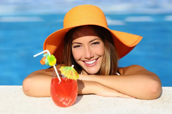 Beauty woman with perfect smile enjoying in a swimming pool on vacations