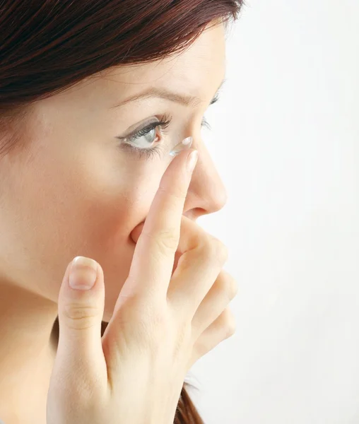 Close-up of woman with contact lens applying