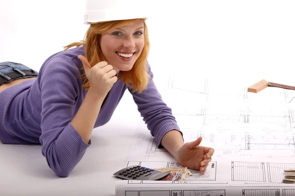 Happy woman with blueprint, helmet, calculators, money