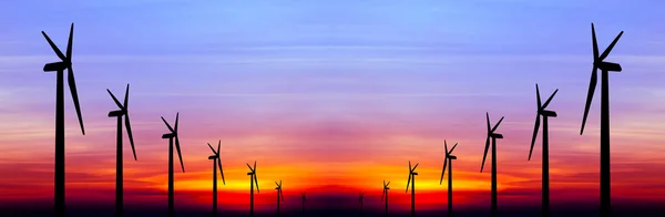 Wind turbine silhouette on colorful sunset