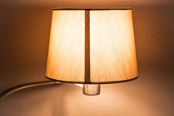 Warm light of work table lamp in room