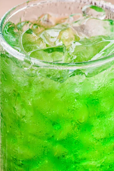 Fresh and cold green drink with ice cubes