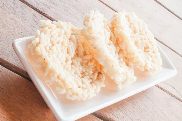 Thai salty crispy rice cracker on white plate