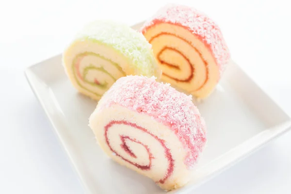 Colorful jam roll cakes on the dish