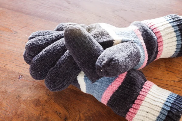 Human hands wear wool gloves