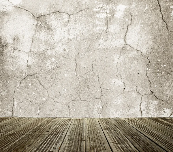 Wall with cracks and wood floor background