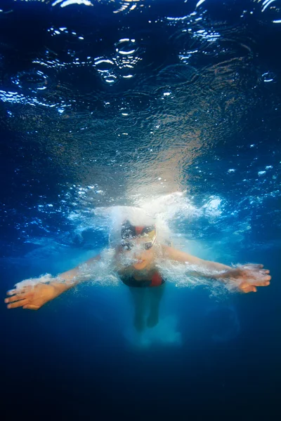 Professional female sport master smiling underwater