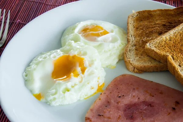 Bacon, fried eggs and toast