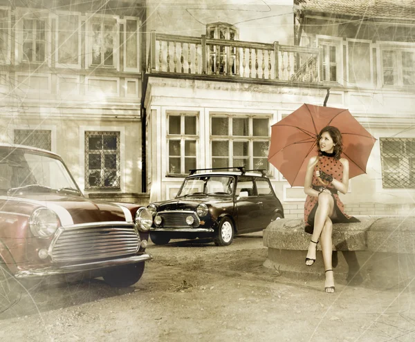 Vintage image of young attractive girl with two old cars