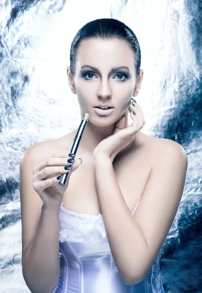 Fashion shoot of a young woman smoking an electronic cigarette