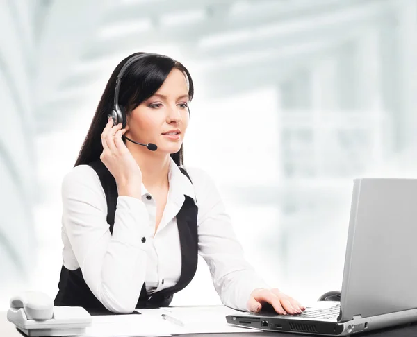Young, confident and beautiful customer support operator working