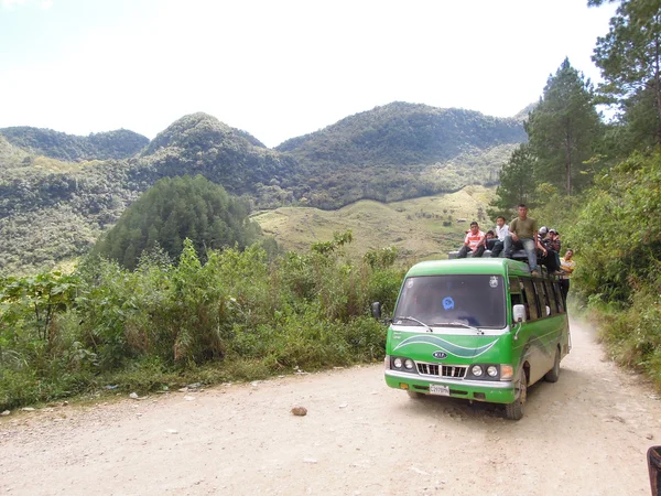 Truck full of people on a dirt mountain road near Lanquin, Guate