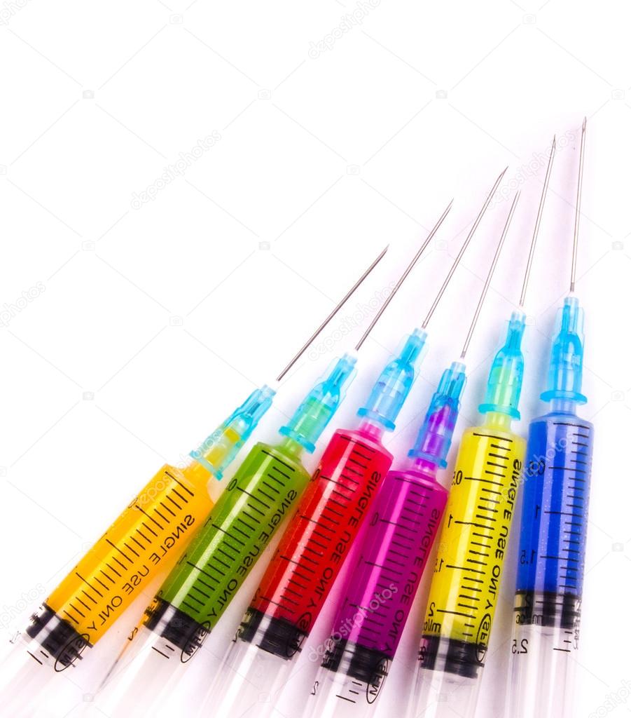 Syringe filled with solution various bright colors — Stock Photo
