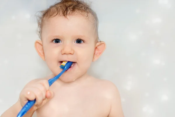 Little baby brushing his teeth