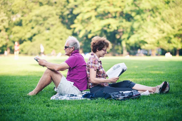 Old couple relaxing outdoors in Central Park on July 1, 2012 in