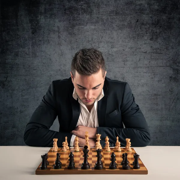 Man playing chess, isolated on dark grunge background