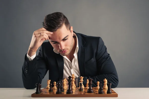 Man playing chess, isolated on dark background
