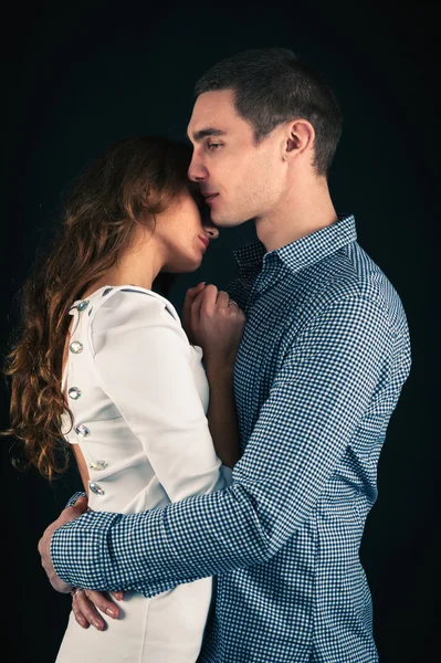 Romantic young couple. Studio portrait on dark background. — Stock Photo #19998983
