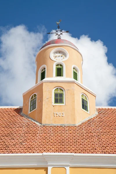 Old clock roof tower with cockerel wind vane