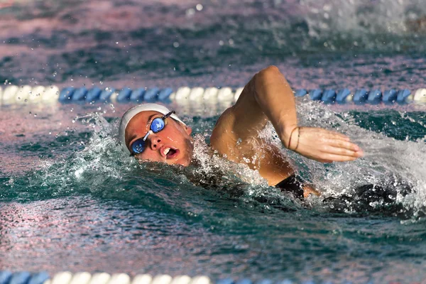 A woman  swimming free style