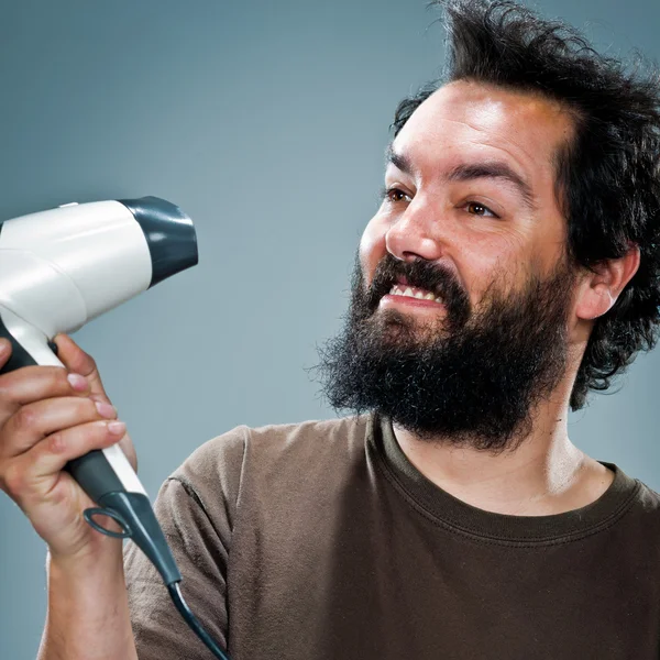 Young Happy Man with an Hair Dryer