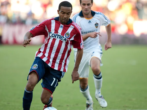 Maykel Galindo (L) dribbles away from Todd Dunivant (R) during the MLS conference semifinal match