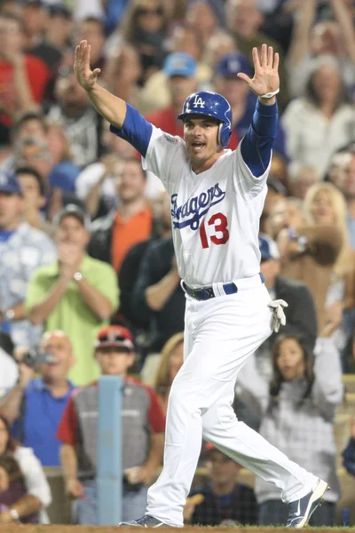 Ryan Theriot reacts to run being scored by his team during the game