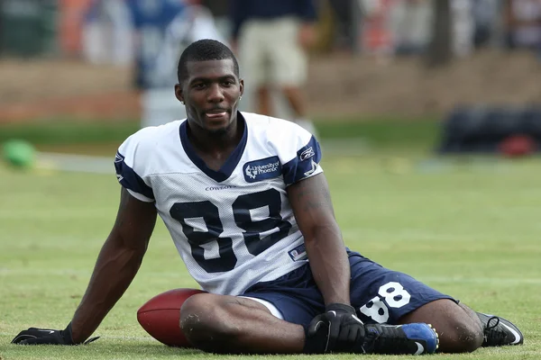 DEZ BRYANT stretches with the team before the start of the second day of the game
