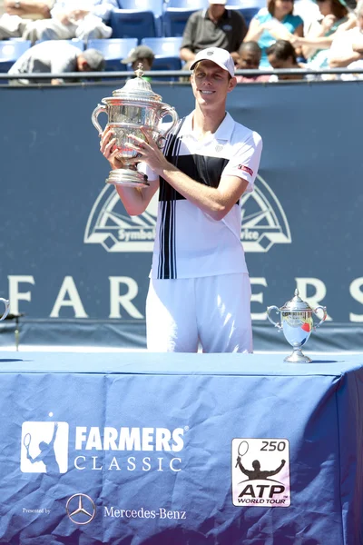 Sam Querrey presents to the crowd the first place perputual trophy and his first place trophy