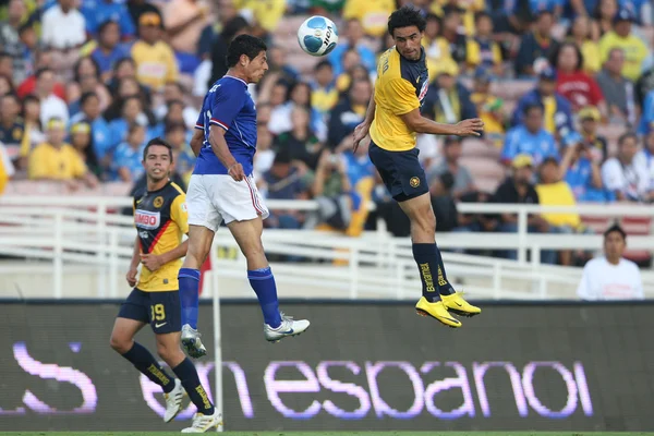 Alejandro Vela and Club America Enrique Esqueda go up for a header during the game