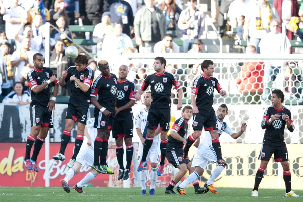 Dejan Jakovic gets a head on the ball as the rest of the wall jumps during the game