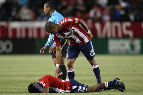 Maicon Santos checks on Michael Lahoud after he took a hit to head during the game