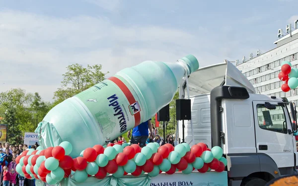 IRKUTSK, RUSSIA - JUNE,2 2012: The carnival on the streets of Irkutsk in honor of the City Day in June,2 2012 in Irkutsk, Russia. Festively decorated car of the factory of bottling of mineral water