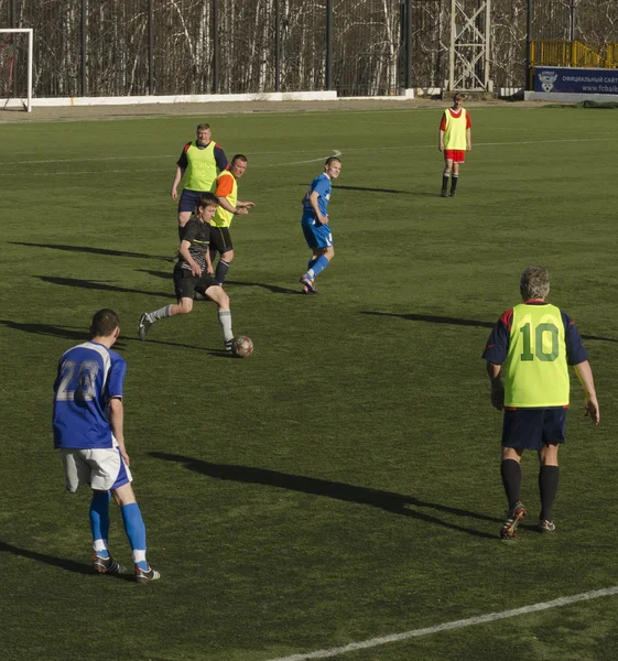 Friendly game between veterans and teenagers from football club \