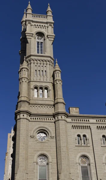 Large mason cathedral located in the USA, the bell tower on a clear blue sunday morning