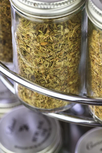 A spice rack close up, filled with fresh organic spices and herbs