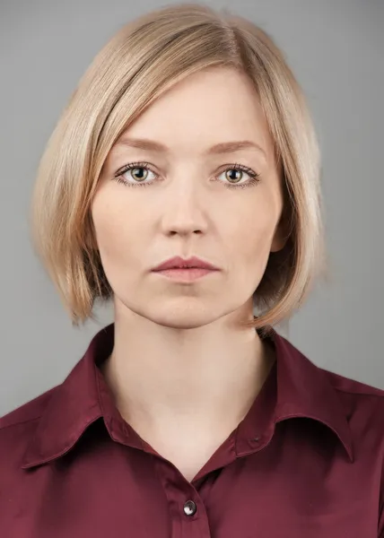 Portrait of pretty blond woman with serious face