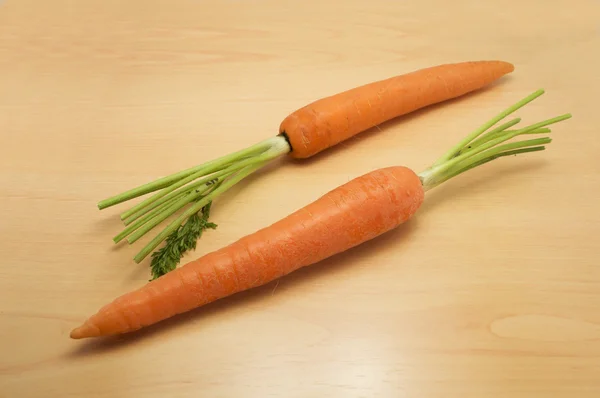 Fresh young carrot vegetable isolated on table background