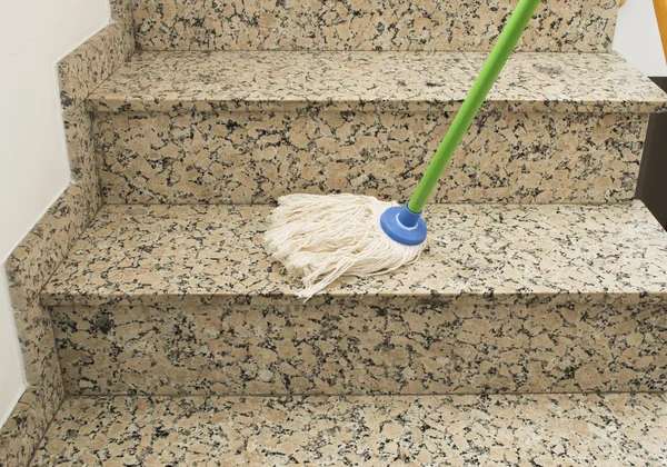 Mop cleaning the stairs marble