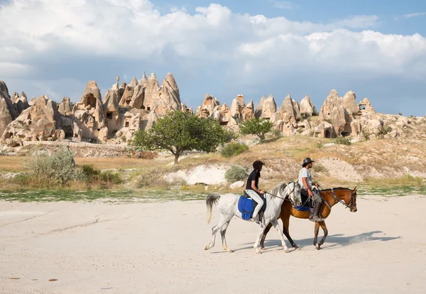 Tourists enjoy ride horses in Cappadocia