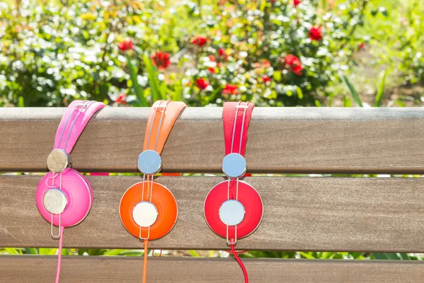Three varicolored headphones of different colors
