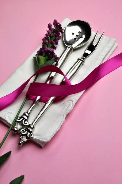 Antique silver spoon and fork table setting in pink theme (vertical)