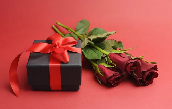 Happy Valentines Day black box with red ribbon gift and red roses