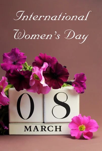 White block calendar for International Women\'s Day, March 8, decorated with pink and purple flowers (vertical)